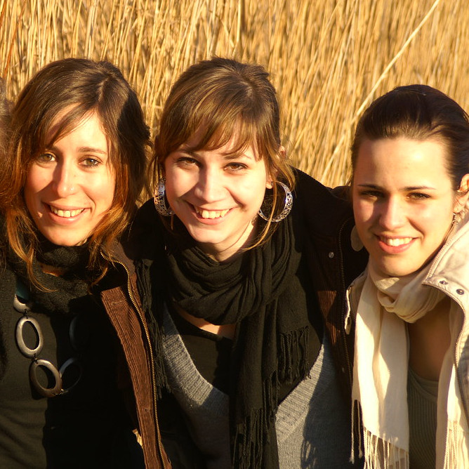 A photo of 3 women who are friends smiling at the camera
